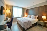 A bed or beds in a room at Adamel City Hotel