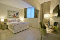 A bed or beds in a room at Adamel City Hotel
