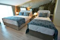 A bed or beds in a room at Adamel City Hotel