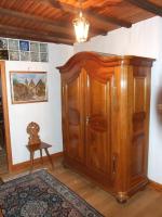 a large wooden cabinet in a room with a rug at Chambre d&#39;Hôtes &quot;Au Vigneron&quot; in Triembach-au-Val