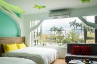 a bedroom with a bed and a window at Apple Tree Bed and Breakfast in Hualien City