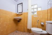a bathroom with a toilet and a sink and a mirror at Palm Leaf Resort Koh Tao in Ko Tao