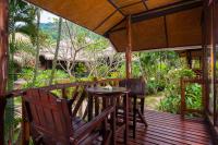 a wooden deck with a table and chairs on it at Palm Leaf Resort Koh Tao in Ko Tao