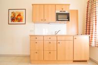 a kitchen with a sink and a microwave at Bauernhofpension Herzog zu Laah in Linz