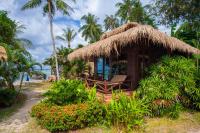 a small hut with a straw roof on the beach at Palm Leaf Resort Koh Tao in Ko Tao