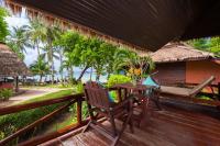 a wooden deck with a table and chairs on it at Palm Leaf Resort Koh Tao in Ko Tao