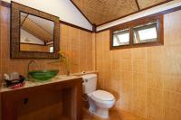 a bathroom with a toilet and a sink and a mirror at Palm Leaf Resort Koh Tao in Ko Tao