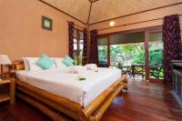 a bedroom with a large bed in a room at Palm Leaf Resort Koh Tao in Ko Tao