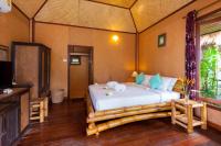 a bedroom with a bed in a room at Palm Leaf Resort Koh Tao in Ko Tao