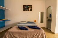 a bedroom with a bed with two pillows on it at Hotel Marina Clube de Pesca in Cananéia