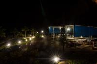 a parking lot at night with lights in front of a building at Hotel Marina Clube de Pesca in Cananéia