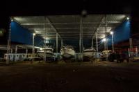 a group of boats parked in a garage at night at Hotel Marina Clube de Pesca in Cananéia