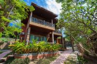 a house in the woods with a pathway leading up to it at Palm Leaf Resort Koh Tao in Ko Tao