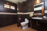 a bathroom with a toilet and a sink and a mirror at Palm Leaf Resort Koh Tao in Ko Tao