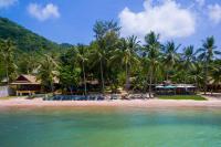 a beach with chairs and palm trees in the water at Palm Leaf Resort Koh Tao in Ko Tao