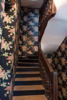 a flight of stairs with floral wallpaper at Hotel Esmeralda in Paris