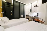 a hotel room with two beds and a sink at Atypik Hotel in Clichy