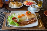 a plate of breakfast food on a table at Panviman Resort Koh Phangan - SHA Extra Plus in Thong Nai Pan Noi