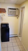 a kitchen with a refrigerator and a air conditioner at Atlantic Motel in Point Pleasant Beach
