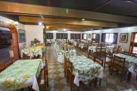 a dining room with tables and chairs with green table cloth at Hotel Pantanal Mato Grosso in Poconé