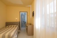 A bed or beds in a room at Hotel Gemma Del Mare