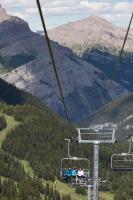a group of people riding on a ski lift at Sunshine Mountain Lodge in Banff