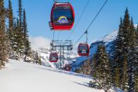 a group of ski lifts flying over a snow covered mountain at Sunshine Mountain Lodge in Banff