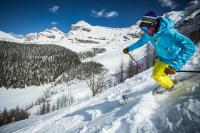 a person is skiing down a snow covered mountain at Sunshine Mountain Lodge in Banff