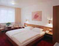 a bedroom with a large bed and a telephone at Hotel Diamant in Wedel
