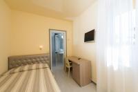 A bed or beds in a room at Hotel Gemma Del Mare