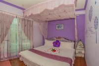 a bedroom with a bed with a canopy at Greek Wonderland B&amp;B in Hualien City