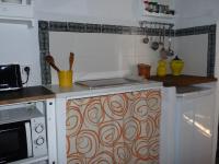 a kitchen with a sink and a stove top oven at Casa Sol in Vejer de la Frontera