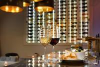 two glasses of wine and a plate of food on a table at Hotel Florenc in Prague
