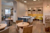 a restaurant with tables and chairs and a cafeteria at Hotel Florenc in Prague