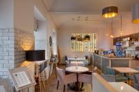 a restaurant with tables and chairs and a bar at Hotel Florenc in Prague