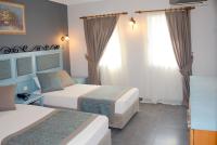 A bed or beds in a room at Hotel Atrium