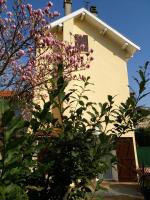 a house with a flowering tree in front of it at Atelier Liberation in Bourgoin