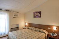 A bed or beds in a room at Albergo La Foresteria