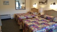 a hotel room with two beds and a mirror at Atlantic Motel in Point Pleasant Beach