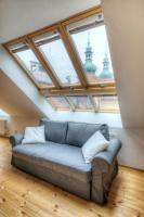 a couch sitting in a room with windows at Residence St Havel Prague Old Town in Prague