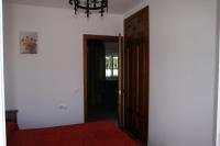 a room with a door open to a room with a chair at Casa Rural El Limonero in Los Naveros