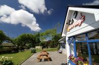 a group of picnic tables outside of a restaurant at Pure Magic Lodge in Slievemore