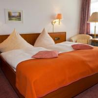 a bed in a hotel room with two pillows on it at Hotel Buck in Bad Urach
