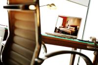a mirror on a desk with a bed in a bedroom at Park Plaza Beijing Wangfujing in Beijing
