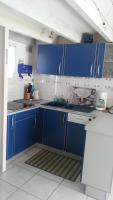 a kitchen with blue cabinets and a sink at La Maison Du Pecheur in La Trinité-sur-Mer