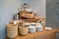 a bunch of plates and baskets on a shelf at Hotel Zur Sonne in Waren