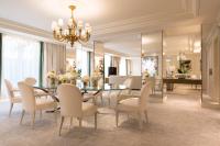 a dining room with a table and chairs at Four Seasons Hotel George V Paris in Paris