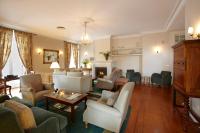 a living room filled with furniture and a fireplace at PortoBay Serra Golf in Santo António da Serra