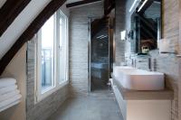 a bathroom with a sink and a glass shower at Hôtel Jacques De Molay in Paris