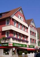 a red and white building with a hotel at Hotel Buck in Bad Urach